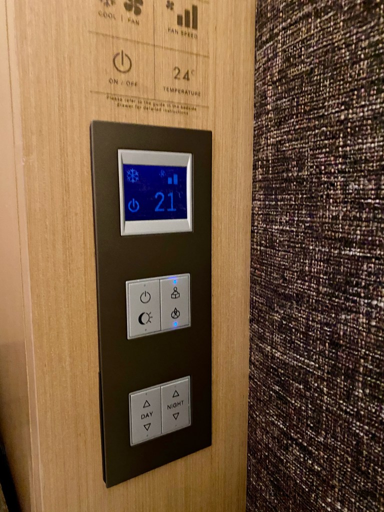 Control panel in the bedroom is mounted on the wall next to the bed