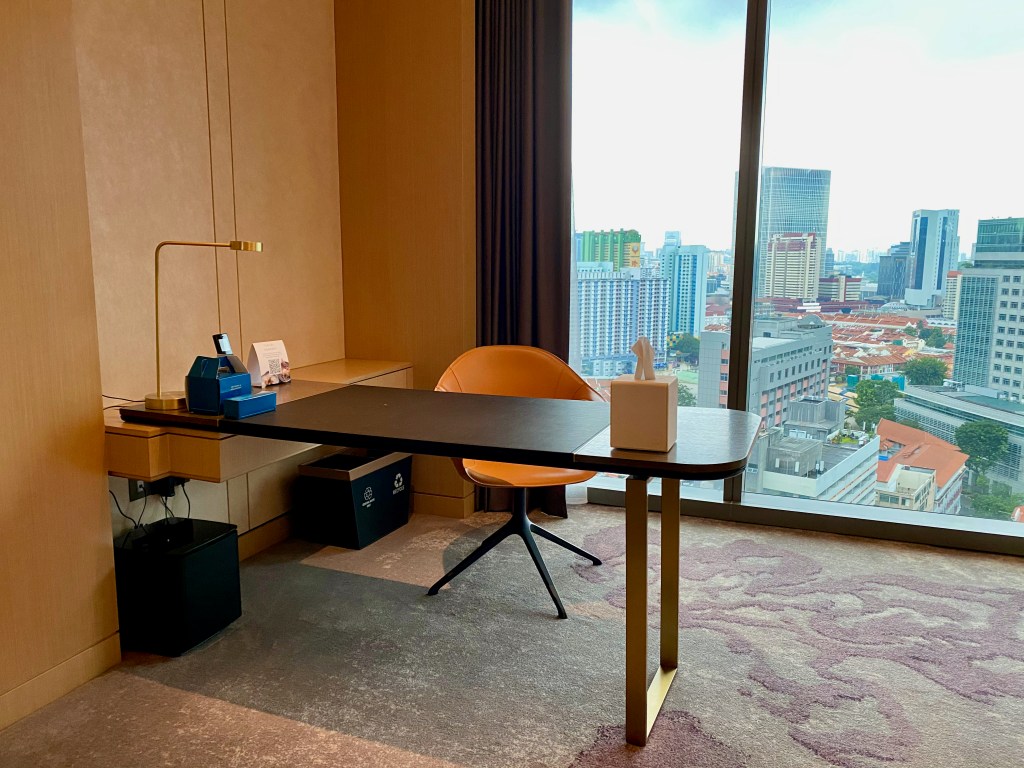 Sizable work desk placed in front of the window